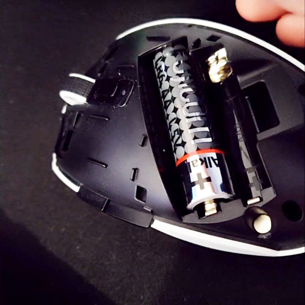 Orochi V2 battery compartment with AA battery installed and a space for AAA battery and the 2.4GHz dongle compartment alongside it.